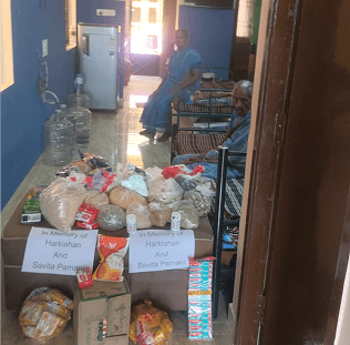 a woman in a room with a lot of food in front of her